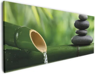 Produktbild von Wallario Premium Leinwandbild Steinstapel und Bambus auf dem Wasser in Größe 50 x 125 cm