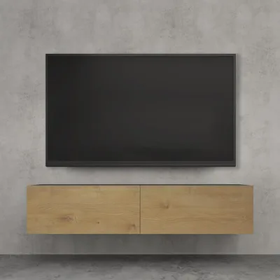 A wall-mounted TV stand with a TV mounted above it, against a concrete wall.