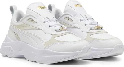 A pair of white Puma sneakers shown from a diagonal angle against a white background.