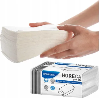 Hands holding a stack of white paper towels, with a packaged stack of paper towels below.