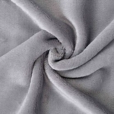 A close-up view of a crumpled grey fabric, likely a blanket or bedsheet.