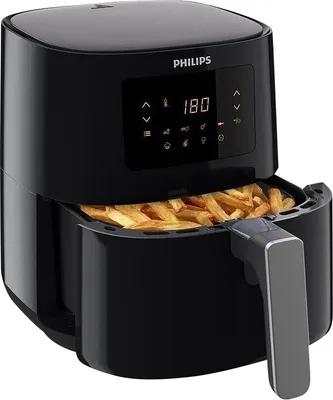 A black Philips air fryer filled with french fries.