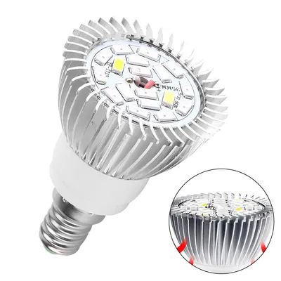 A close-up view of an LED grow light bulb with a silver aluminum heat sink and a white base.