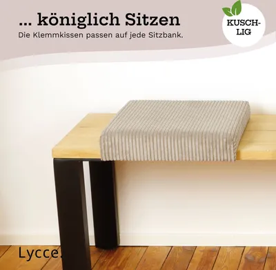 A cushion on a wooden bench with black legs.