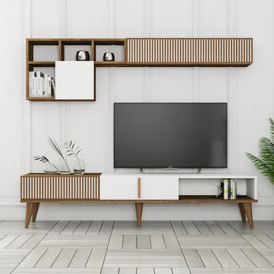 A modern TV unit with a television mounted above it, set against a white paneled wall.