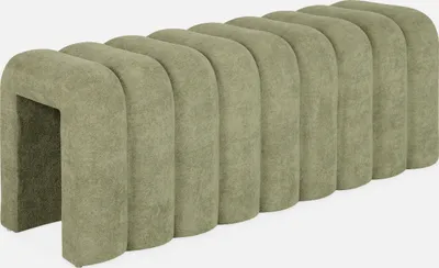 A green upholstered bench with a curved, segmented design.