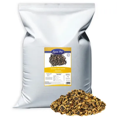 A large white bag of pet food with a label and a pile of the food in front of it.
