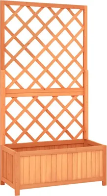 A wooden planter box with a trellis attached.