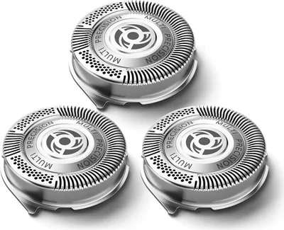 Three replacement shaver heads are arranged in a triangular formation on a white background.
