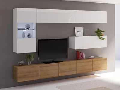 A modern living room wall unit with a TV, cabinets, and shelves.