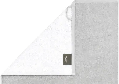 A folded towel is shown against a white background. A small tag with the brand name is visible.