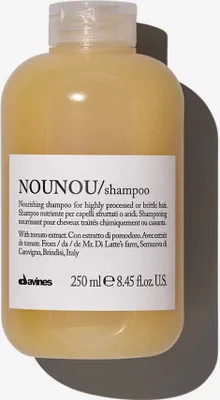 A bottle of Davines Nounou shampoo on a white background with a shadow.