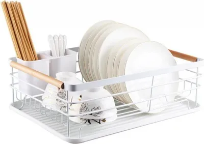 A white dish drying rack with plates, bowls, and chopsticks.