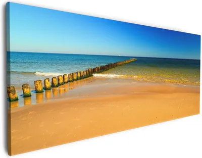 Produktbild von Wallario Premium Leinwandbild Sandstrand in orange - Blaues Meer - Blauer Himmel in Größe 50 x 125 cm
