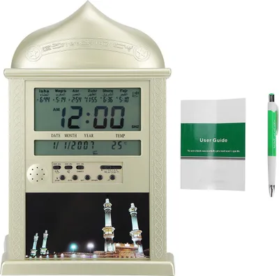 A digital Islamic clock with a user guide and pen.