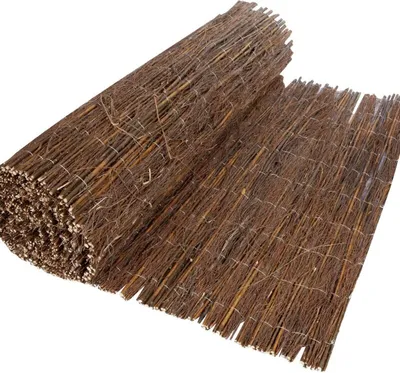 A rolled-up privacy screen made of natural materials.