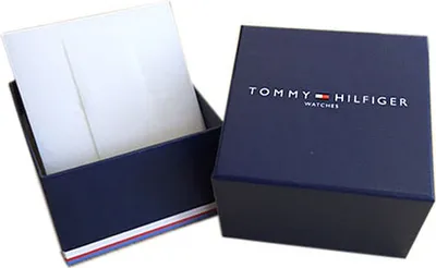 An open navy blue Tommy Hilfiger watch box with white interior packaging.