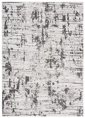 A close-up, flat lay image of a rug with a distressed, abstract pattern.