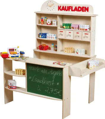 A wooden toy shop counter with shelves stocked with toy food items and accessories, a cash register, and a chalkboard displaying prices.