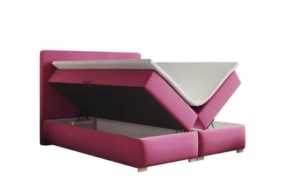 A pink upholstered bed frame with the mattress and topper lifted to reveal storage space underneath.