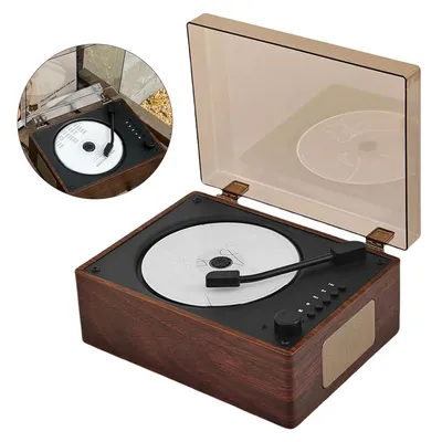A close-up, angled view of a portable CD player with a wooden-grain finish, showing the open lid and the CD inside.