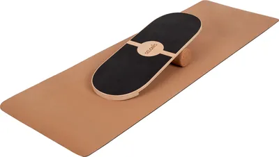 A balance board and roller are placed on a yoga mat.