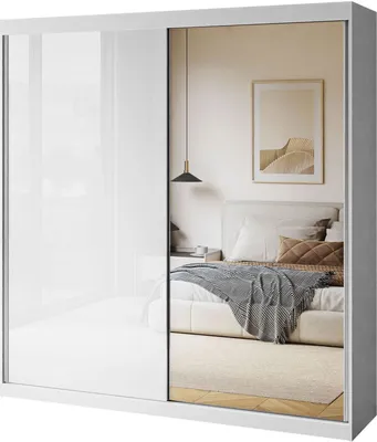 A white sliding door wardrobe with a mirrored door, reflecting a bedroom scene.