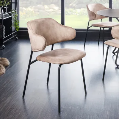 A dining room setting with chairs around a table, with a window in the background.