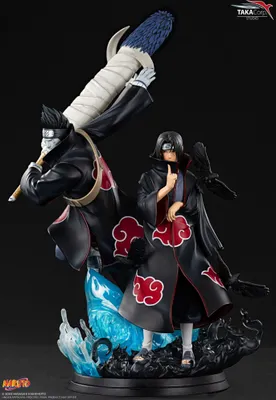 A statue of two anime characters, Itachi and Kisame, from Naruto Shippuden, standing on a dark, rocky base with blue water effects.
