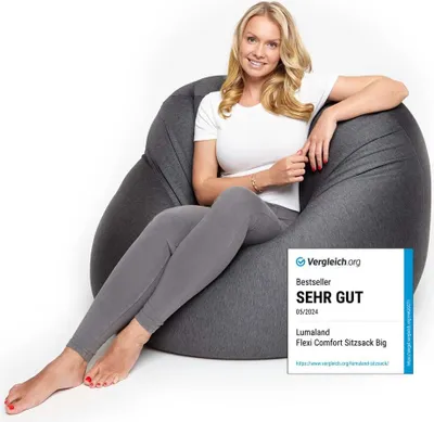 A woman is sitting on a large beanbag chair.