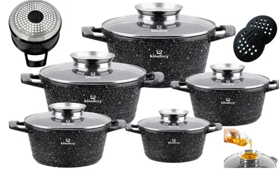 A set of five black speckled pots with glass lids and silver handles, arranged on a white background. Accessories like a pot lid and a small glass of oil are also visible.