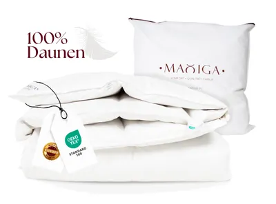 A stack of white bedding products, including a folded duvet and a pillow in a bag, with product tags attached.