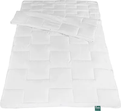 A white duvet laid out flat on a white background.