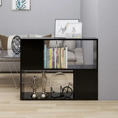 A black TV stand with books and decorative items on it, placed in a living room setting.