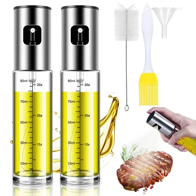 Two oil spray bottles with accessories and a piece of grilled meat.