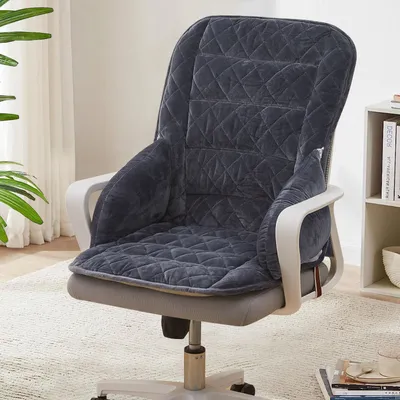 A dark gray quilted seat and back cushion set is placed on an office chair.