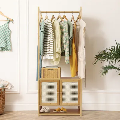 A clothing rack with a cabinet and shoes on the floor, in a room with white walls and wooden flooring.