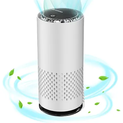 A white cylindrical air purifier with a perforated base and a black top control panel, shown with blue swirling air and green leaves indicating air purification.