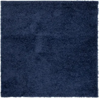 A close-up, top-down view of a dark blue shaggy rug.