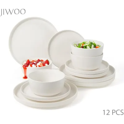 A collection of white ceramic dishes, including plates and bowls, arranged on a white background.