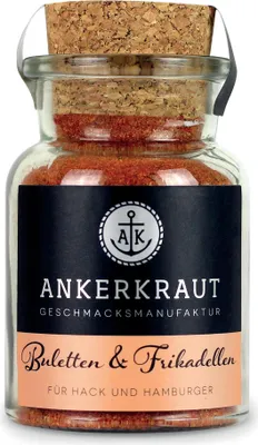 A glass jar filled with red spice, sealed with a cork and labeled with product information.