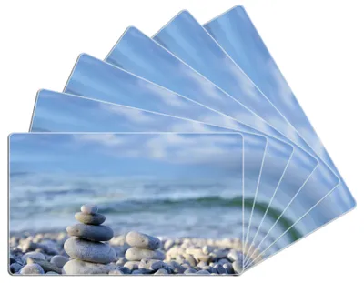 Produktbild von Wallario Frühstücksbrettchen 6er Set aus Glas, je 14 x 23 cm, mit rutschfesten Füßen, Motiv Steinstapel am Strand
