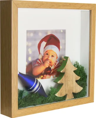 A Christmas-themed shadow box frame with a baby photo and decorative elements.