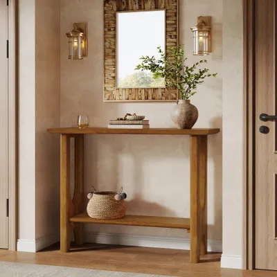 A console table with a mirror and decorative items in a hallway.