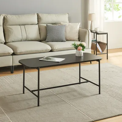 A living room scene with a couch, coffee table, and side table.