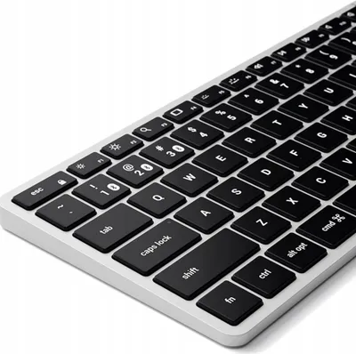 A close-up, angled view of a black and gray wireless keyboard against a white background.