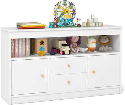 A white wooden toy cabinet filled with toys and books.