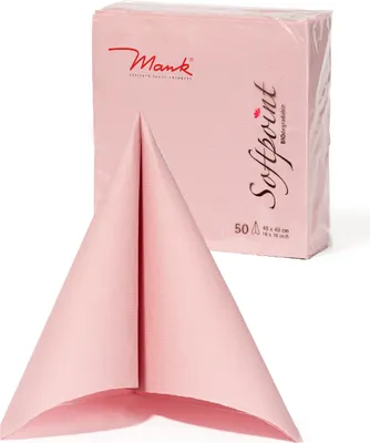 A pink napkin is folded in front of a stack of pink napkins in packaging.