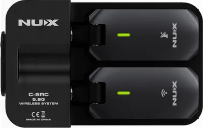 A black NUX C-5RC 5.8G wireless system for guitar, shown in its charging dock.