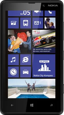 A Nokia Lumia smartphone displaying its home screen with various app tiles and a photo of people jumping into a pool.